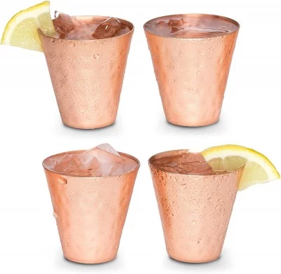 four copper shot glasses with lemon slices