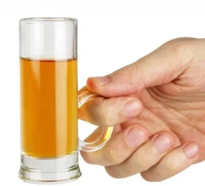 hand holding shot glass by handle